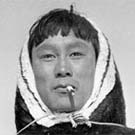 Photograph of a young Inuit man smoking, Beverly Lake, Nunavut, 1949