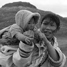 Photograph of Uksawalli and her baby and an Inuit girl on their way to church, Cape Dorset (Kinngait), Nunavut, August 1961