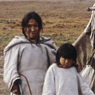 Photograph of three Inuit girls in front of a tent, vicinity of Clyde River (Kangiqtugaapik), Nunavut, no date