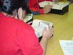 Photograph of Cathy Anablak of Cambridge Bay (Iqaluktuuttiaq) and classmate from Nunavut Sivuniksavut Training Program, searching the card catalogues at Library and Archives Canada, Ottawa, October 2005