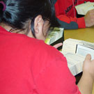Photograph of Cathy Anablak of Cambridge Bay (Iqaluktuuttiaq) and classmate from Nunavut Sivuniksavut Training Program, searching the card catalogues at Library and Archives Canada, Ottawa, October 2005