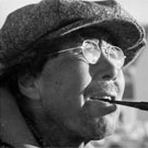 Photograph of an Inuit man wearing eye glasses and a wool cap and smoking a pipe, Pangnirtung (Pangnirtuuq), Nunavut, August 1946